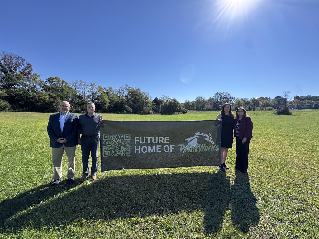 MELD PrintWorks Future Location Banner Economic Development staff poses with MELD Printworks CEO and President with a banner advertising the future home of MELD PrintWorks in Falling Branch Corporate Park